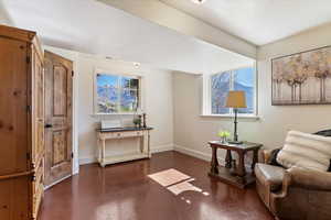 Living area with finished concrete flooring, a textured ceiling, and plenty of natural light