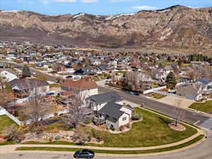 Aerial view of property's location featuring a mountainous background and nearby suburban area