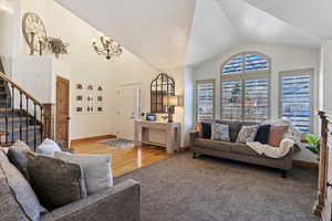 Living room featuring lofted ceiling and light wood-style floors