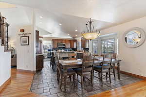 Dining area featuring light wood-style floors, recessed lighting, and vaulted ceiling