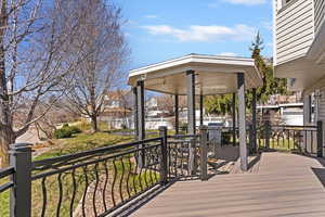 Deck with a gazebo, area for grilling, and a residential view