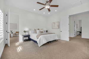 Bedroom with light colored carpet, ceiling fan, and recessed lighting