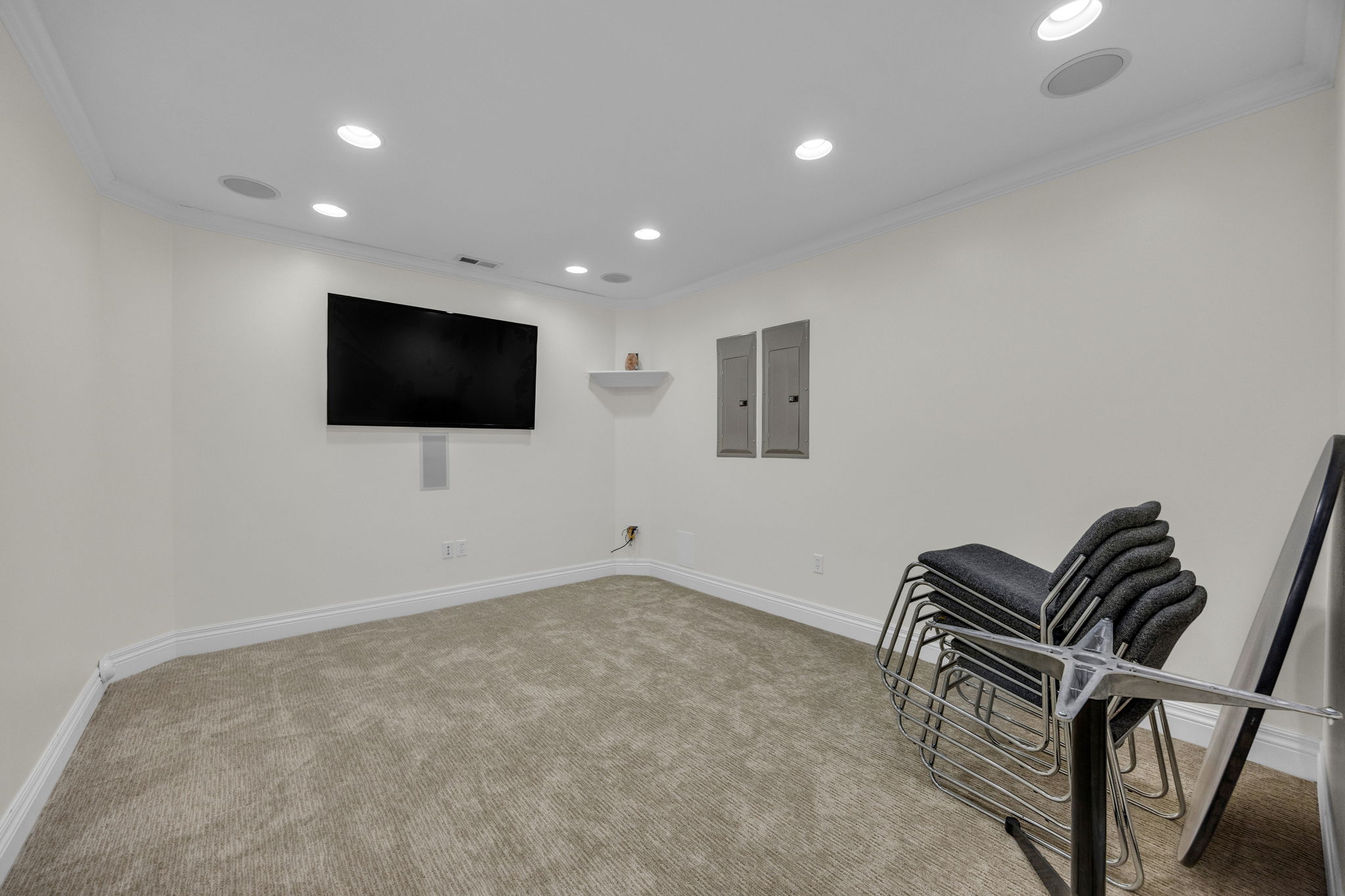 Unfurnished room with recessed lighting, ornamental molding, electric panel, and light colored carpet