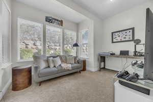 Office with light colored carpet and baseboards