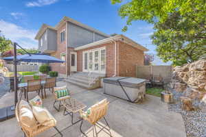 View of patio / terrace featuring outdoor dining space and a hot tub