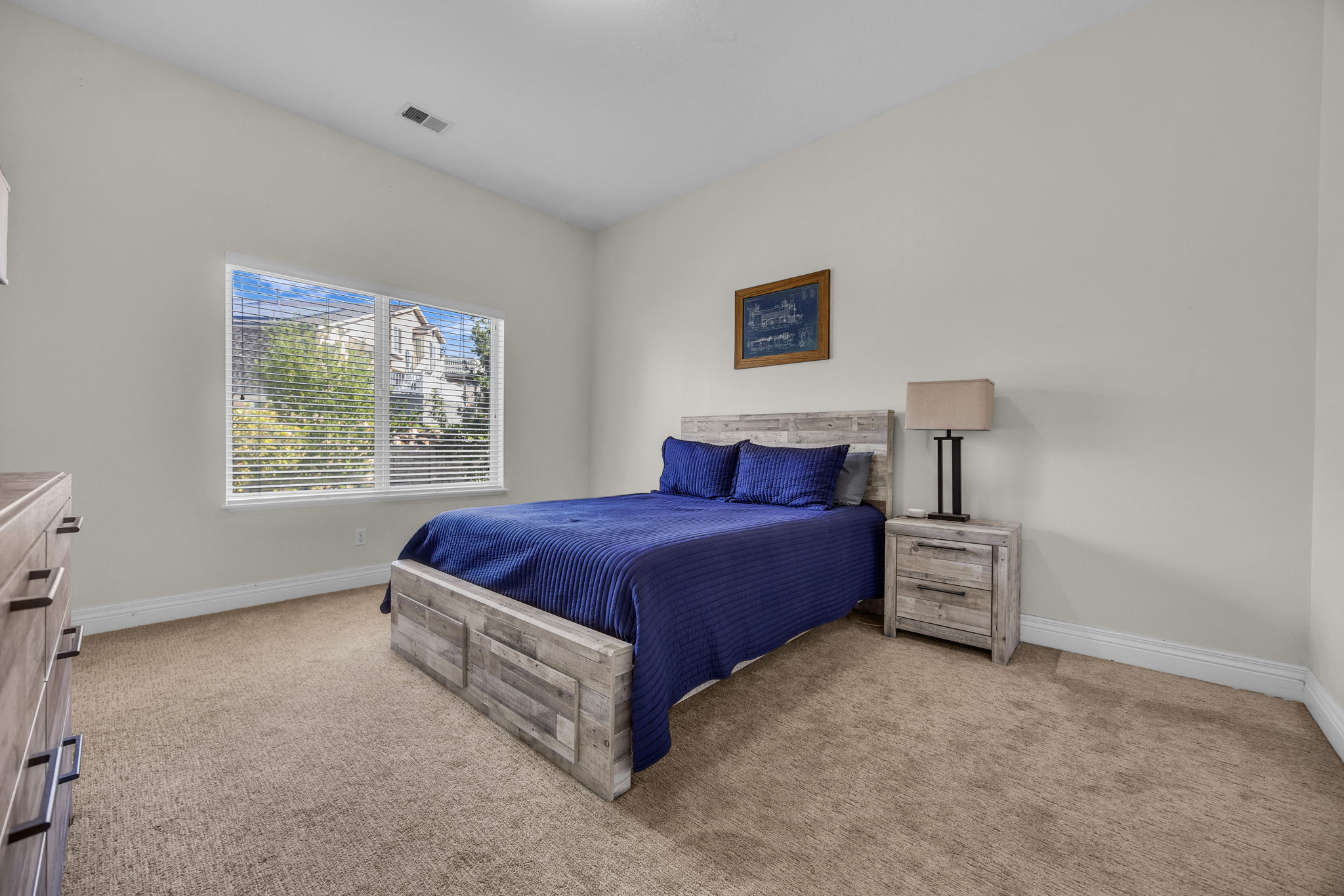 Bedroom with light colored carpet and baseboards