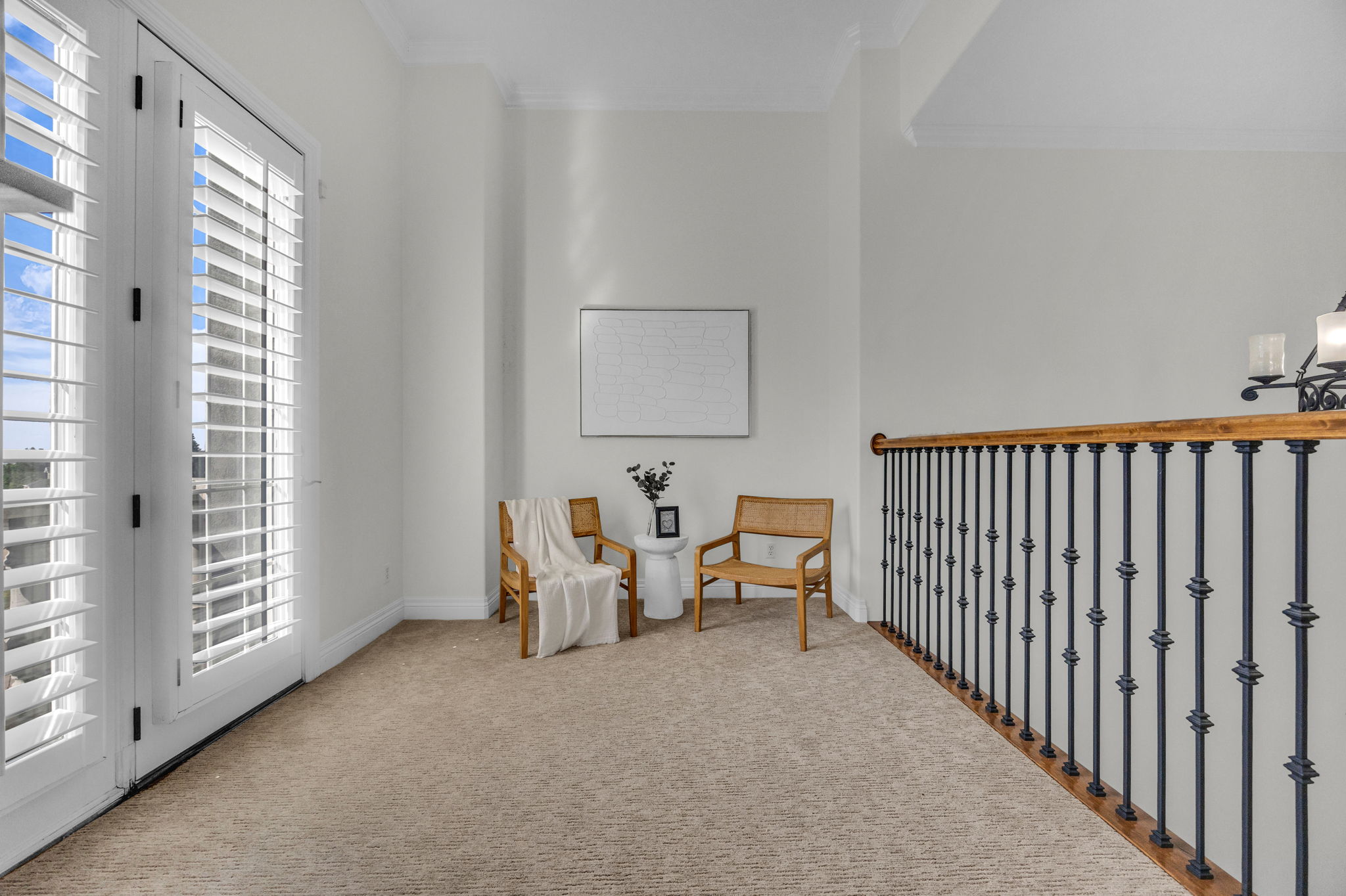 Sitting room featuring carpet, crown molding, and suspended lighting