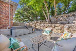 View of patio with a hot tub