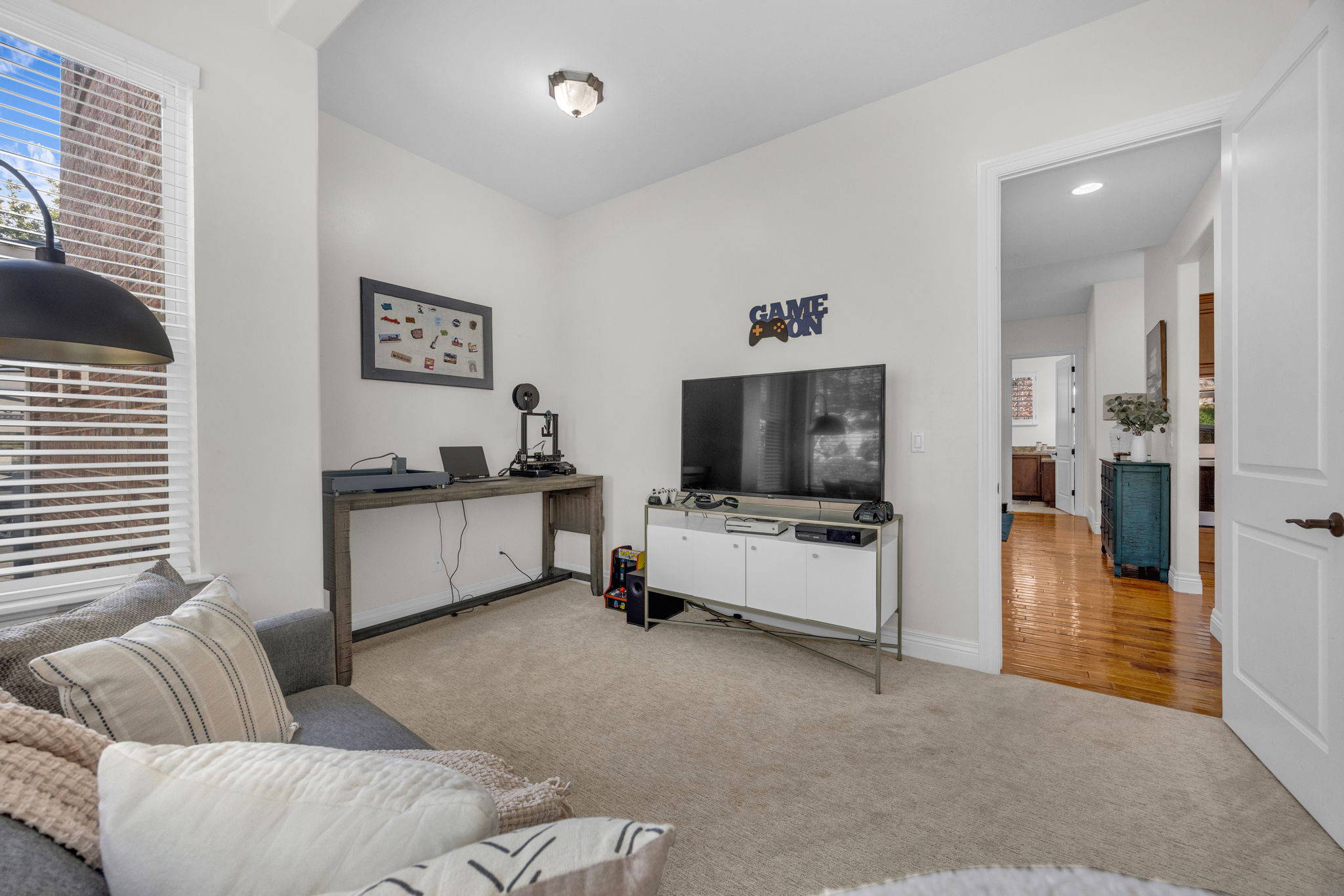 Living area featuring light colored carpet and baseboards