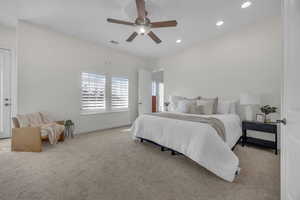 Carpeted bedroom with ceiling fan and recessed lighting
