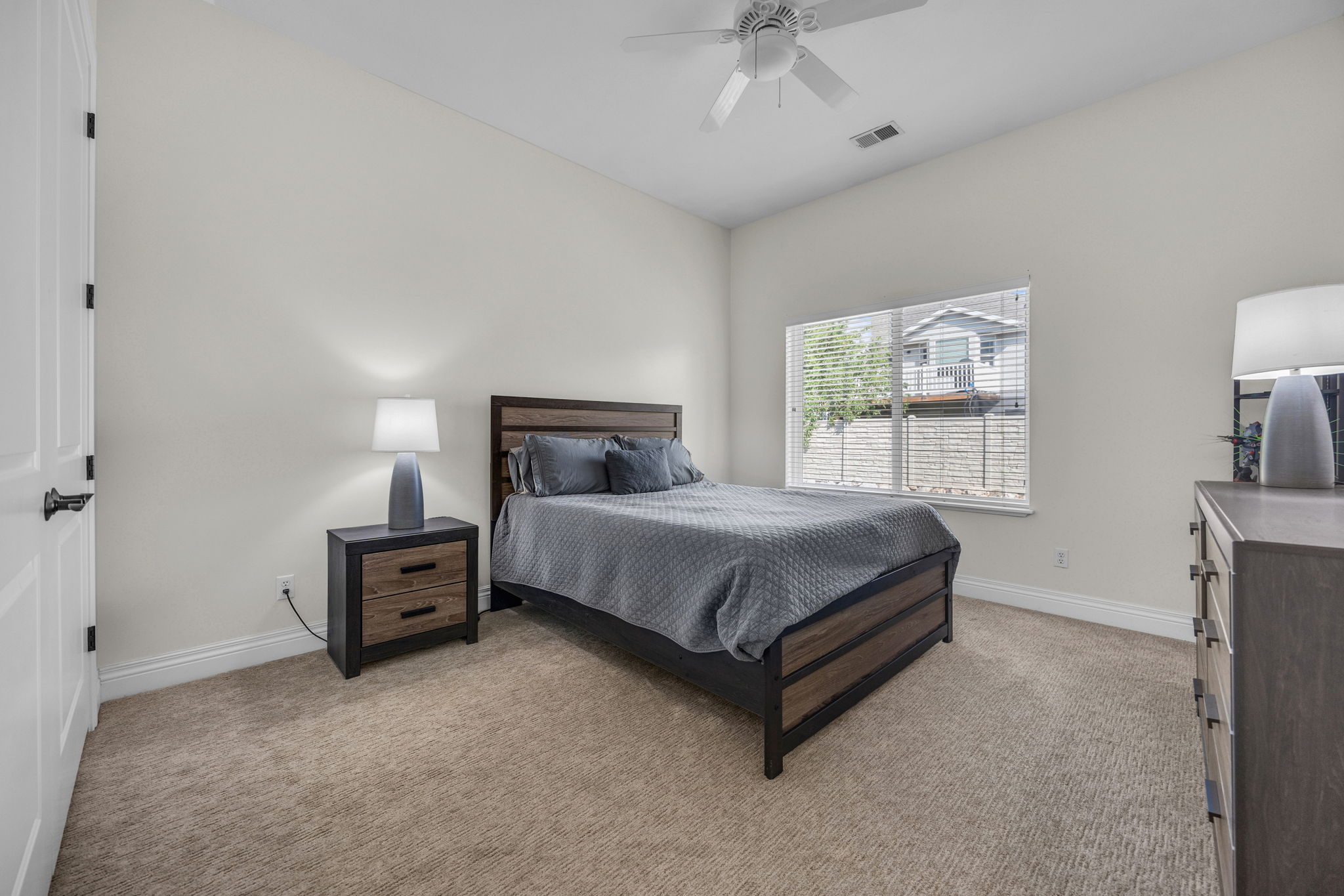 Bedroom featuring light colored carpet and a ceiling fan