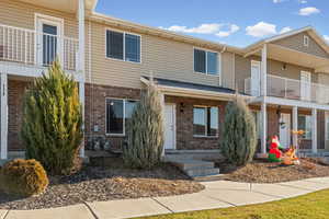Traditional-style home with a balcony and brick siding