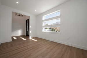 Empty room with wood finished floors and recessed lighting