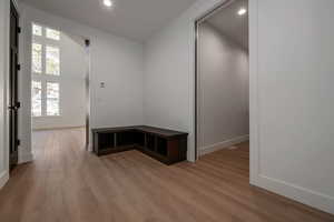 Mudroom featuring light wood-style flooring and recessed lighting