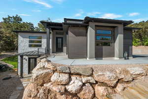 Contemporary house featuring stone siding