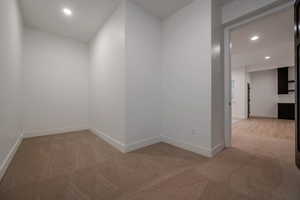 Unfurnished room with recessed lighting and light colored carpet
