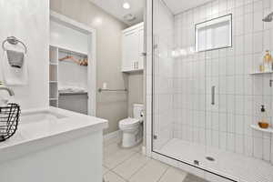 Full bathroom featuring vanity, a shower stall, recessed lighting, and light tile patterned floors