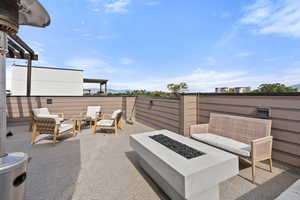 View of patio / terrace with an outdoor living space with a fire pit