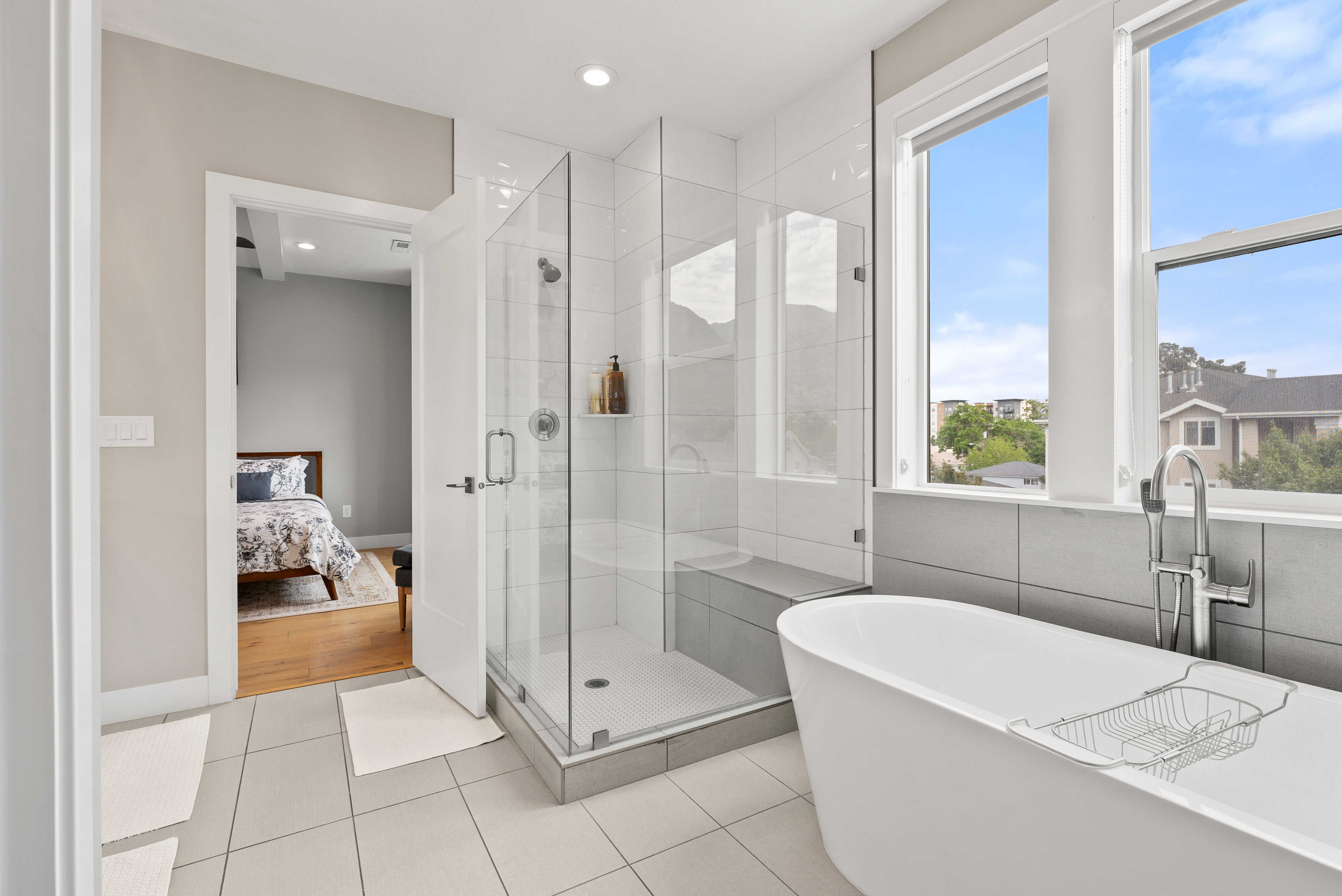 Ensuite bathroom with a stall shower, a soaking tub, light tile patterned flooring, and recessed lighting