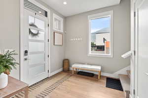 Entryway with light wood-style floors and recessed lighting