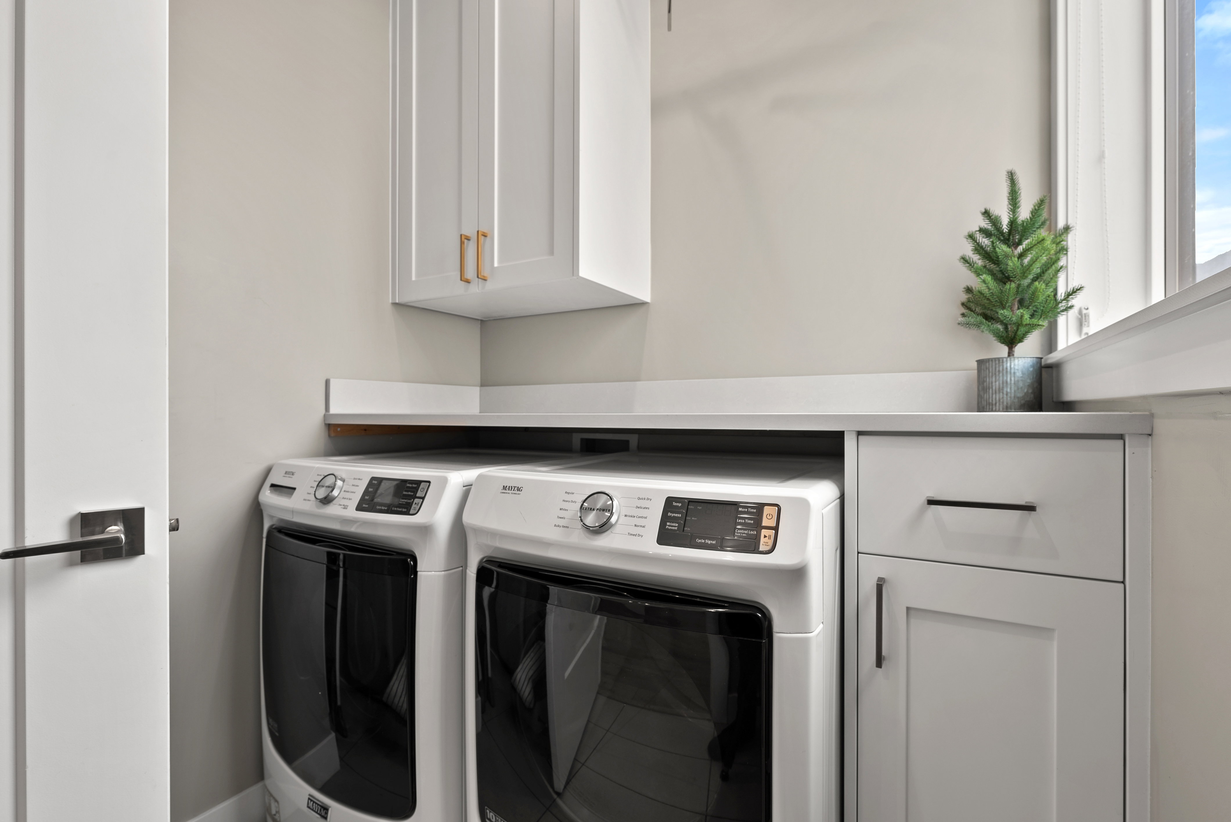 Laundry area featuring cabinet space and separate washer and dryer