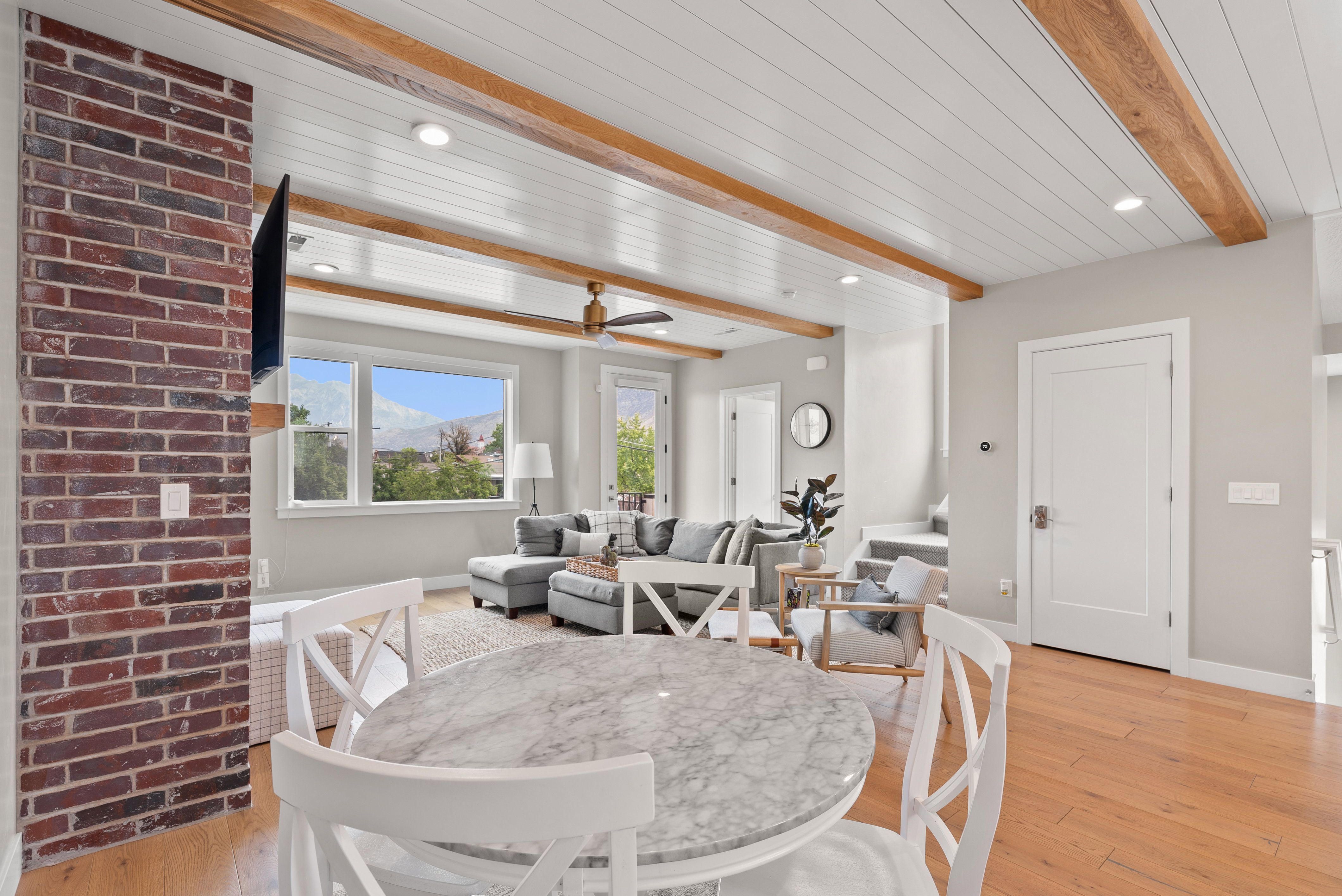 Dining area featuring light wood-style flooring, beamed ceiling, recessed lighting, and ceiling fan