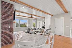 Dining area featuring light wood-style flooring, beamed ceiling, recessed lighting, and ceiling fan