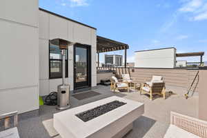 View of patio featuring an outdoor living space with a fire pit