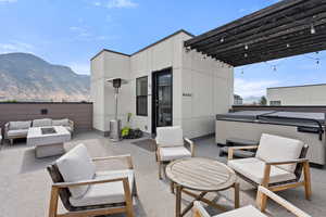 View of patio featuring an outdoor living space with a fire pit and a mountain view