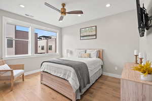 Bedroom featuring light wood-type flooring, a ceiling fan, and recessed lighting