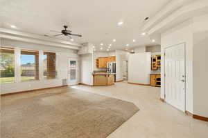 Unfurnished living room featuring ceiling fan and recessed lighting