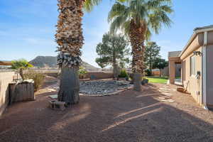 Fenced backyard featuring a patio area and a mountain view