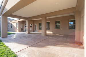 Rear view of house with stucco siding and a patio area