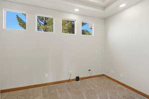 Unfurnished room with light colored carpet and recessed lighting