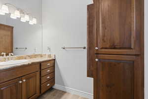 Bathroom featuring vanity and baseboards