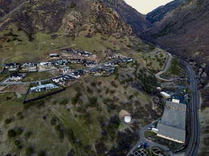 Aerial view of property and surrounding area with a mountain backdrop