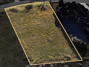 Aerial view of property and surrounding area featuring property parcel outlined
