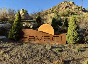 Community / neighborhood sign featuring a mountain view