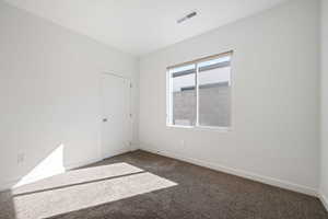 Empty room with baseboards and carpet