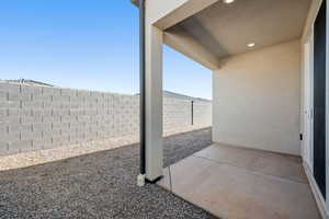 Fenced backyard with a patio