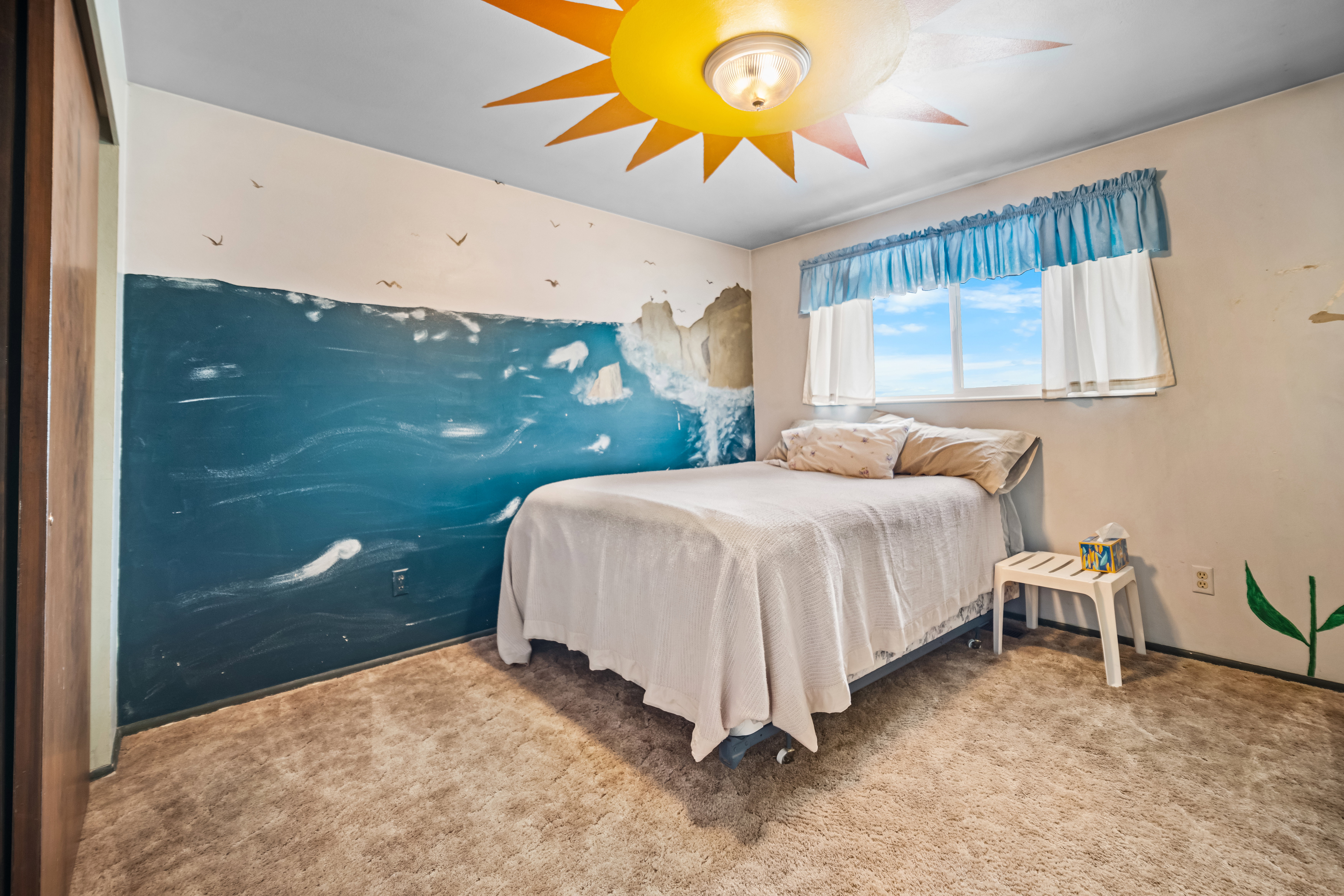Carpeted bedroom featuring a ceiling fan
