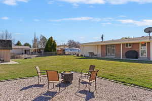 Fully fenced yard with a covered patio for relaxing or entertaining, and a 16 x 16 gravel area that’s perfect for a fire pit sitting space