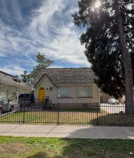 View of front of house featuring a fenced front yard and stucco siding