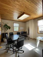 Home office featuring wooden ceiling, light colored carpet, and cooling unit