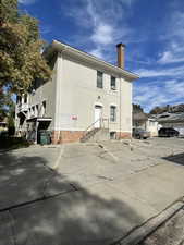View of building exterior with uncovered parking