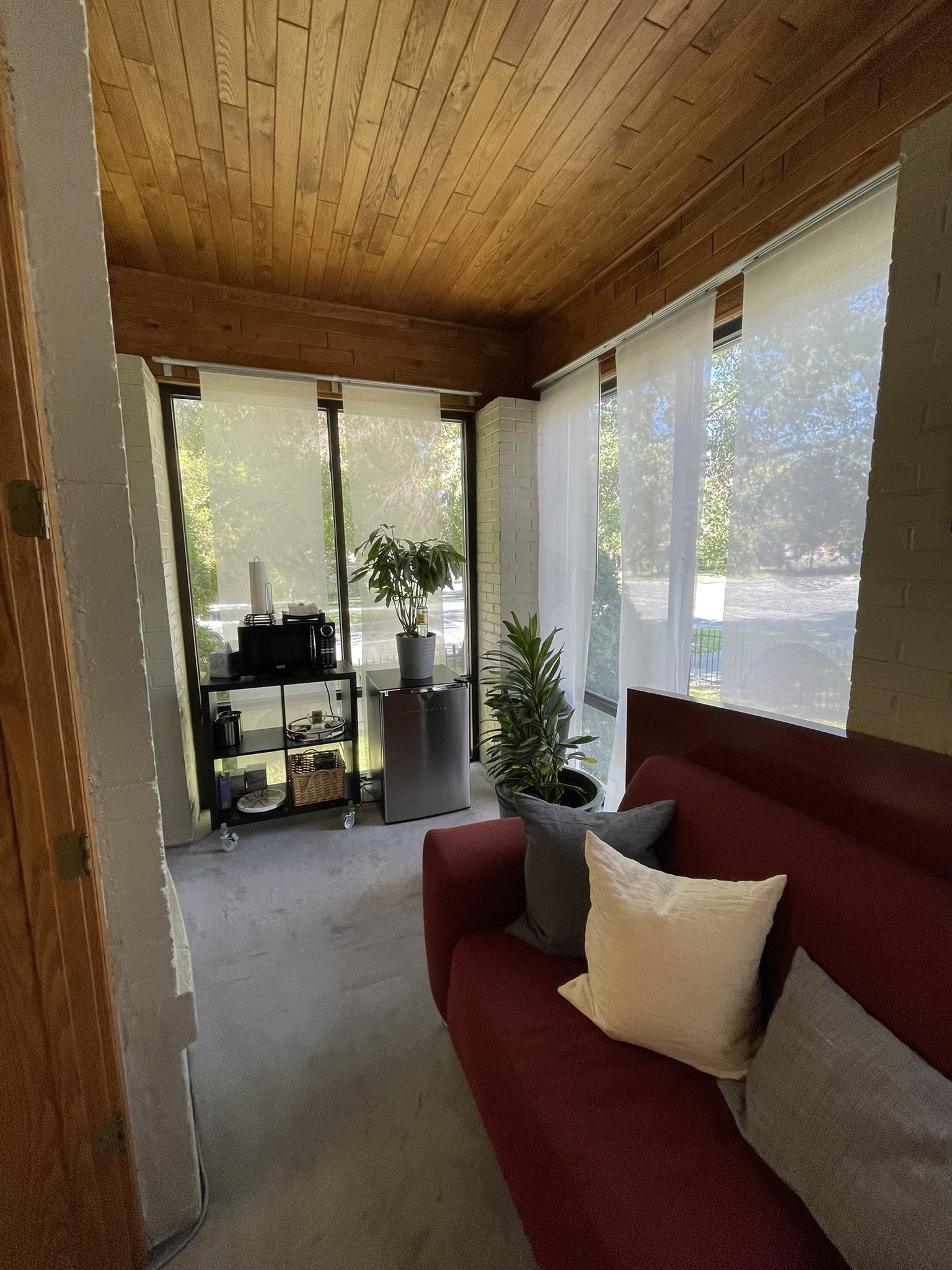 Sunroom / solarium with carpet flooring, wooden ceiling, and plenty of natural light