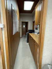 Corridor with wood walls and light colored carpet