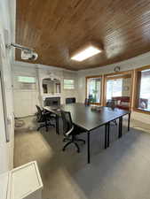 Office space featuring wood ceiling and a fireplace