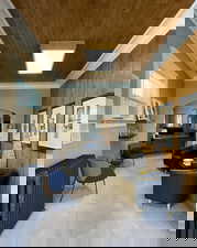 Lobby with wood walls, crown molding, and wood ceiling