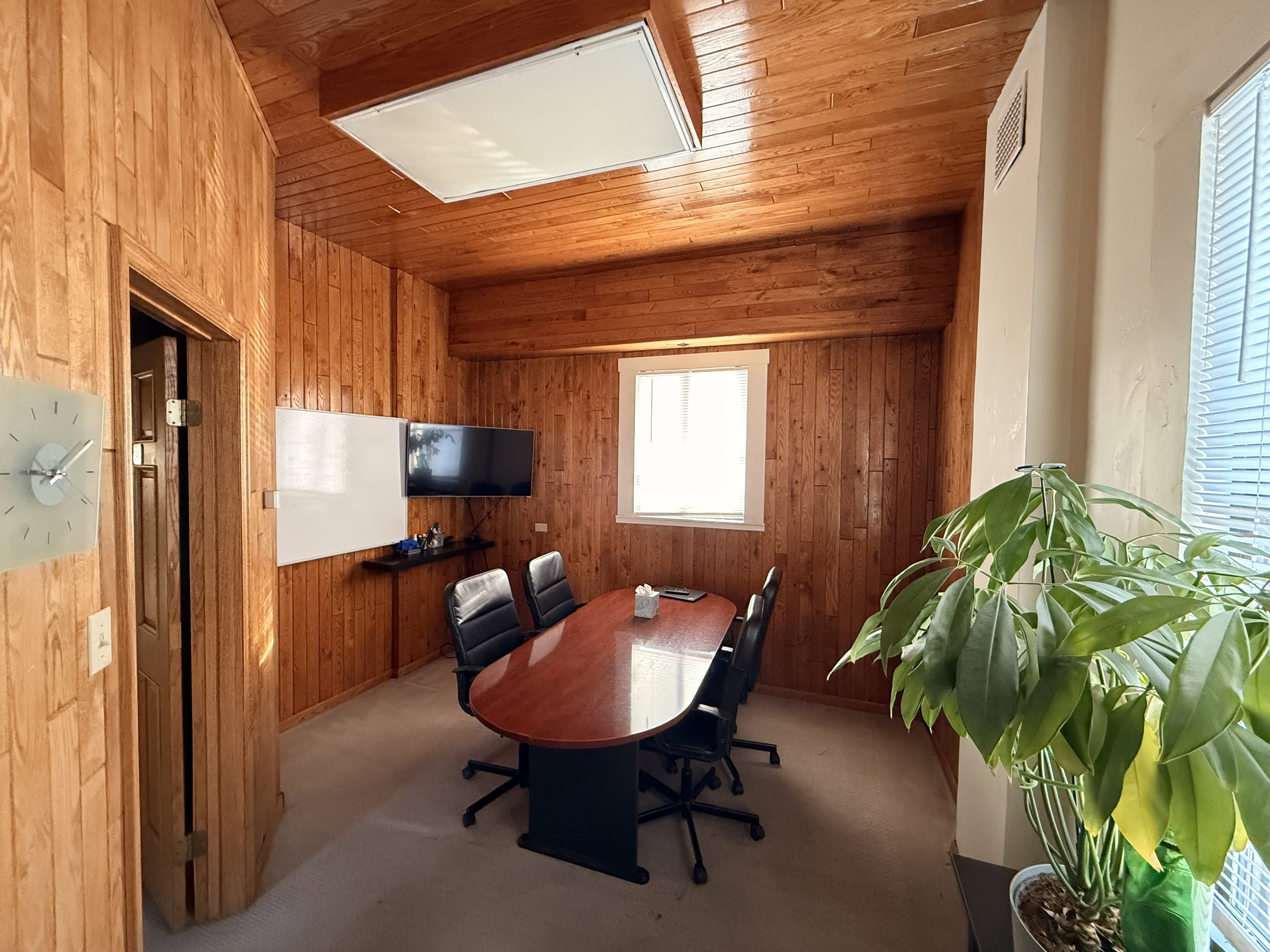 Home office with wood walls, carpet, and wooden ceiling